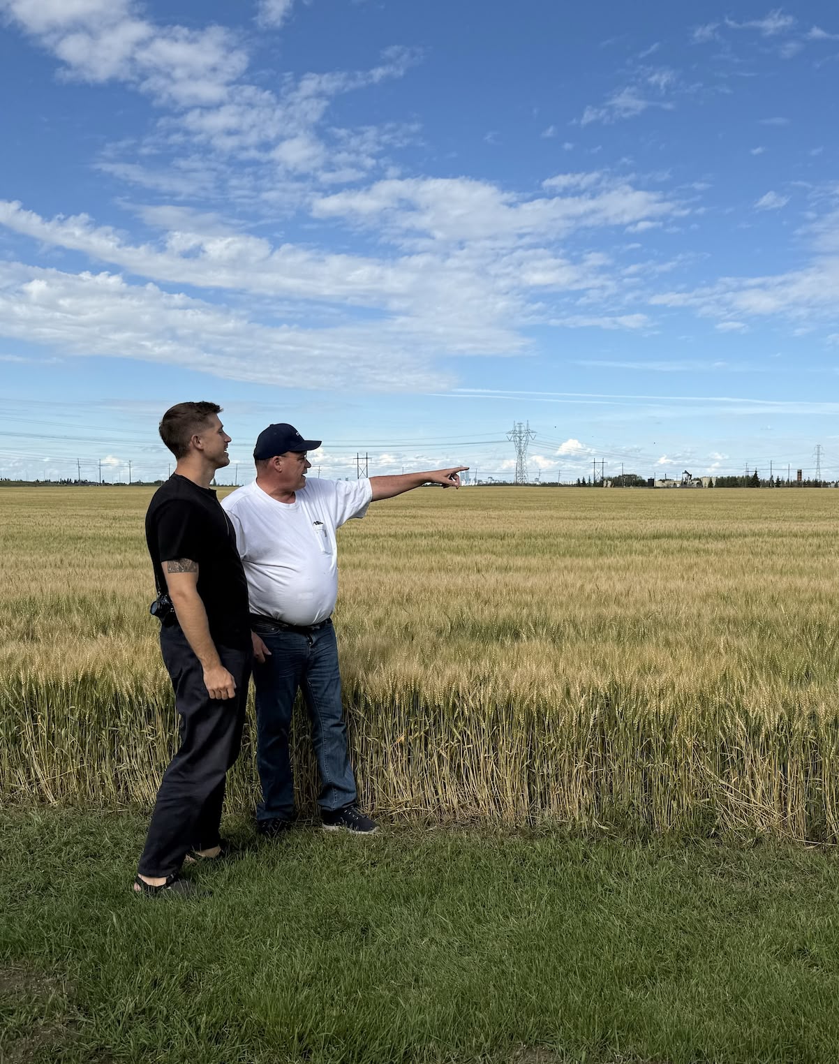 Rural Albertans pointing at oil and gas infrastructure across their farmland, showing the human impact of the well cleanup crisis